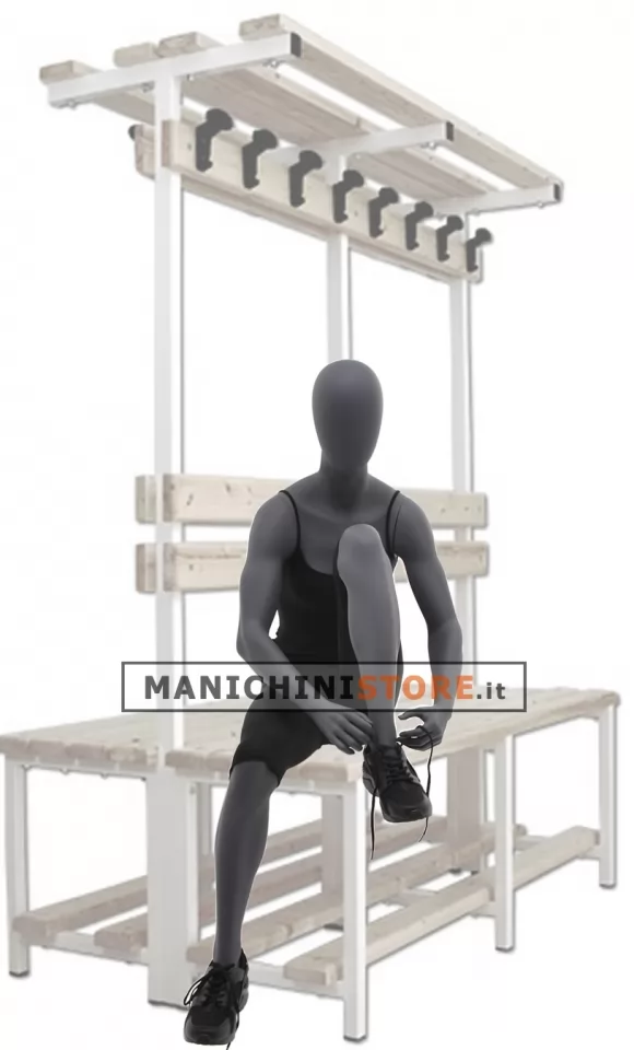 Manichino sportivo donna dalla testa a uovo seduto